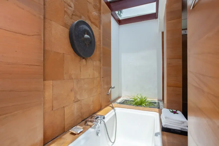 Essence du Sud 28 Salle de bain semi-ouverte avec baignoire et matériaux naturels au Nakamanda Krabi